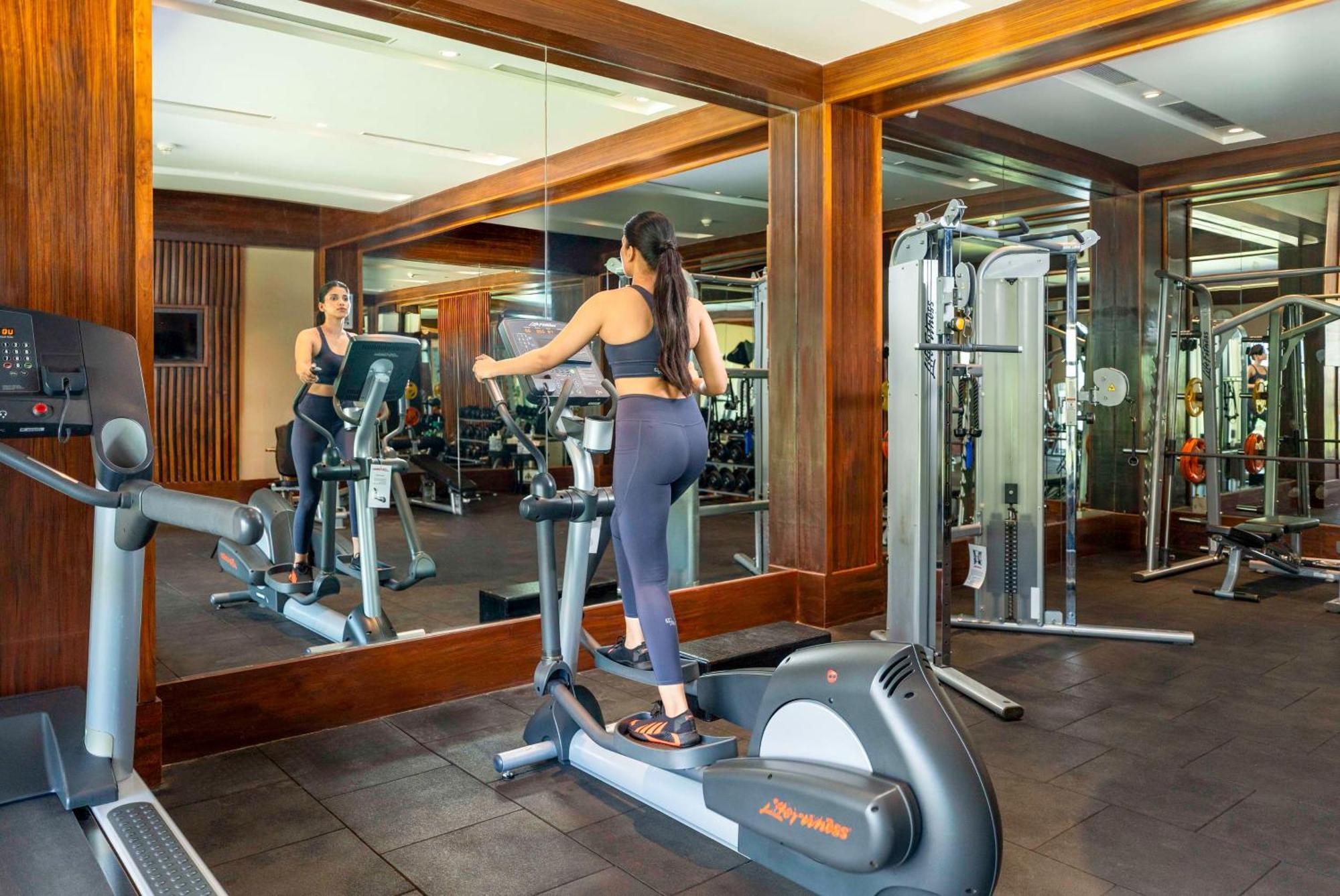 Radisson Blu Plaza Resort & Convention Centre Karjat Εξωτερικό φωτογραφία A woman on an elliptical trainer